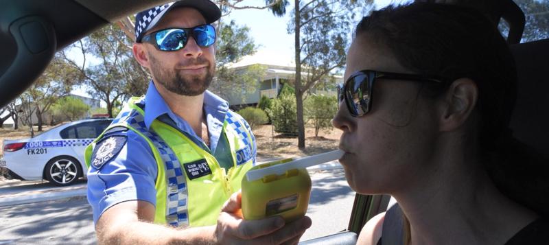 woman takes breathalyzer test after dui stop in oregon