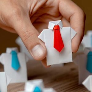 A toy piece made of shirt and tie sets, all ties are blue except on toy that has a red tie.