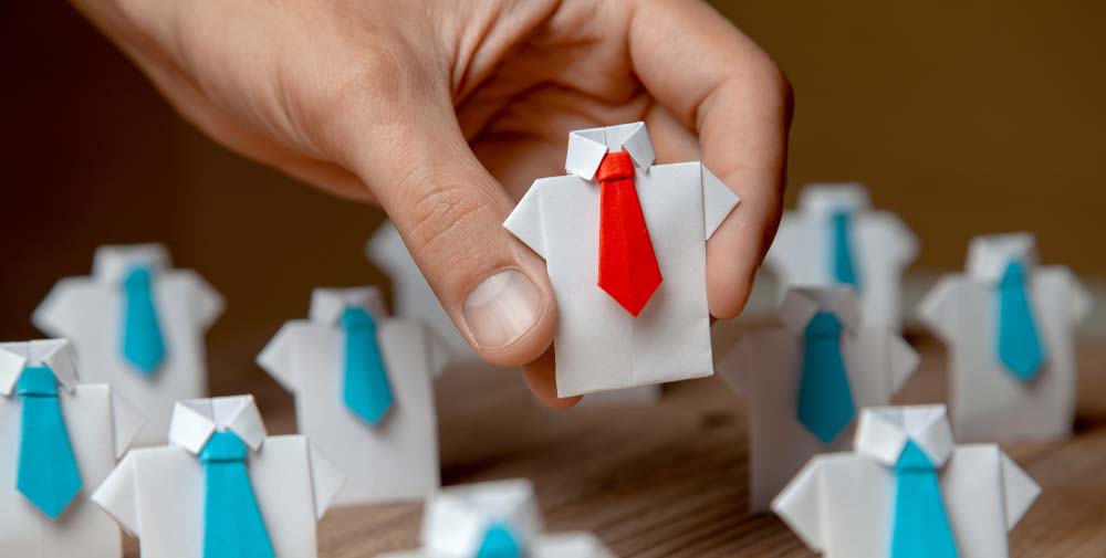 A toy piece made of shirt and tie sets, all ties are blue except on toy that has a red tie.